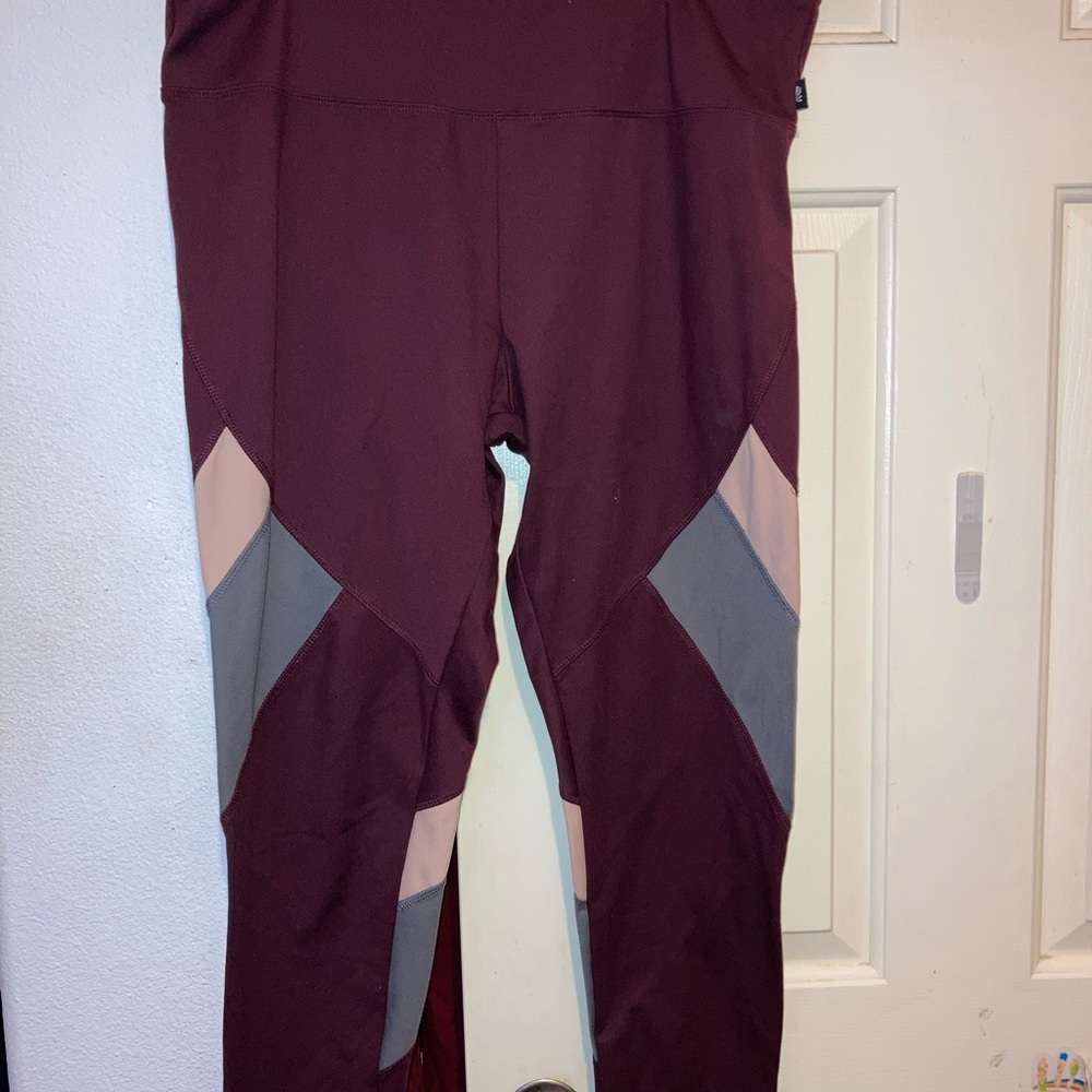 Maroon leggings with grey and pink strips by the knee/lower thigh!